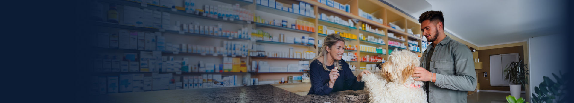 A woman greeting a dog in a pharmacy